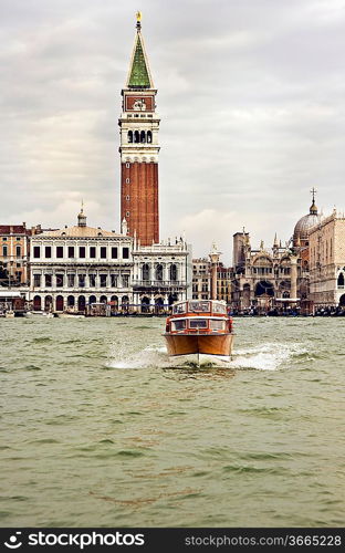 A boat on a venice canal with buildings in the background