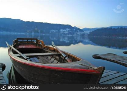 A boat sits still on Lake Bled, Slovenia.