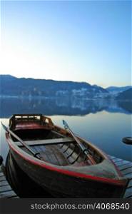 A boat sits still on Lake Bled, Slovenia.