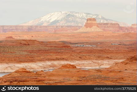 A boat storage lot is tucked away in the red rock landscape of lake powell