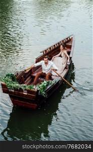 a boat trip for a guy and a girl along the canals and bays of the river overgrown with wild willows