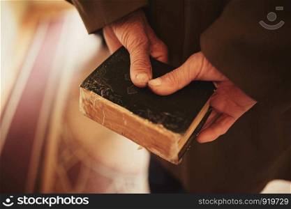 a book in the hands of an old man.. a book in the hands of an old man. little bible