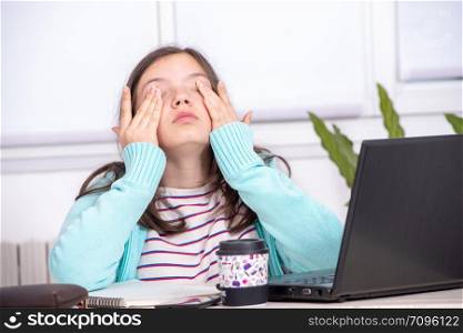 a bored teenage girl is doing her homework