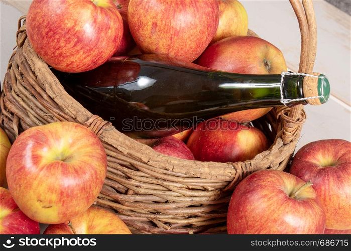 a bottle of cider and beautiful organic apples