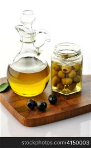A bottle of olive oil with olives