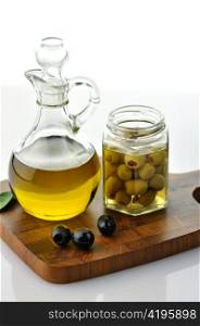 A bottle of olive oil with olives