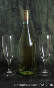 A bottle of wine and two glasses isolated on painted background