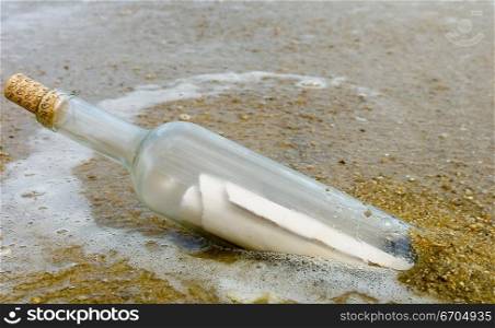 A bottle with a message inside washes ashore. Melbourne Australia.