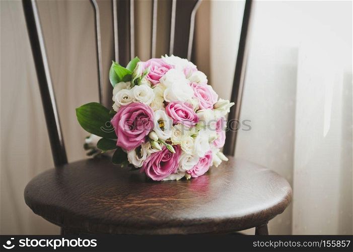 A bouquet of flowers lying on the stool.. A bouquet of flowers on a stool 6806.