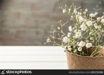 A bouquet of gypsophila flowers on the wooden table. Vintage style image. Copy space