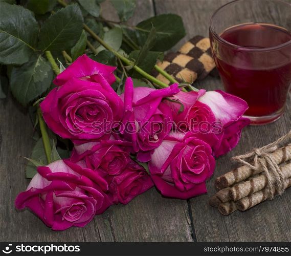 a bouquet of red roses and tea close-up