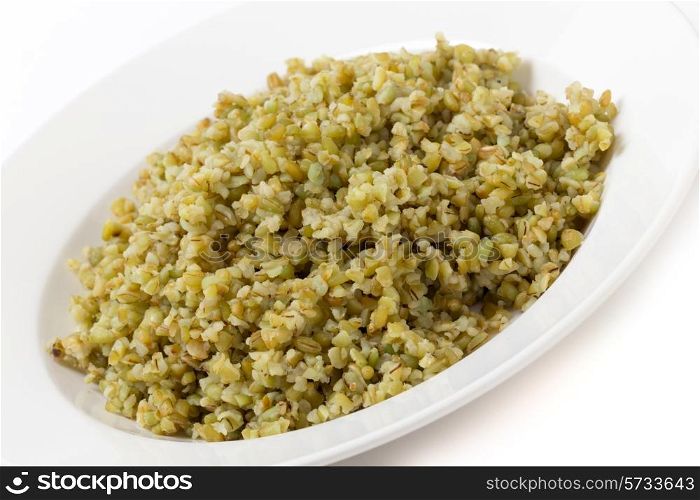 "A bowl of freshly boiled cracked freekeh scorched green wheat grains, one of the "paleo superfoods". It can be eaten as it is or used in a wide range of dishes."
