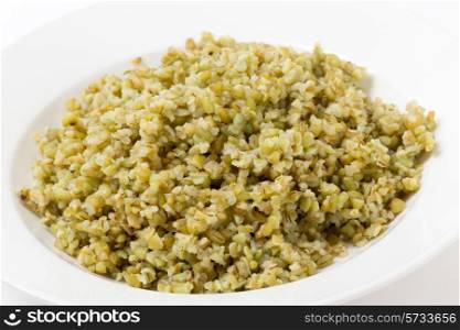 "A bowl of freshly boiled cracked freekeh scorched green wheat grains, one of the "paleo superfoods". It can be eaten as it is or used in a wide range of dishes."