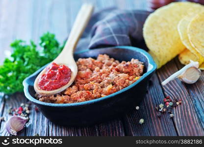 a bowl of fried ground meat with tomatoes ready for tacos