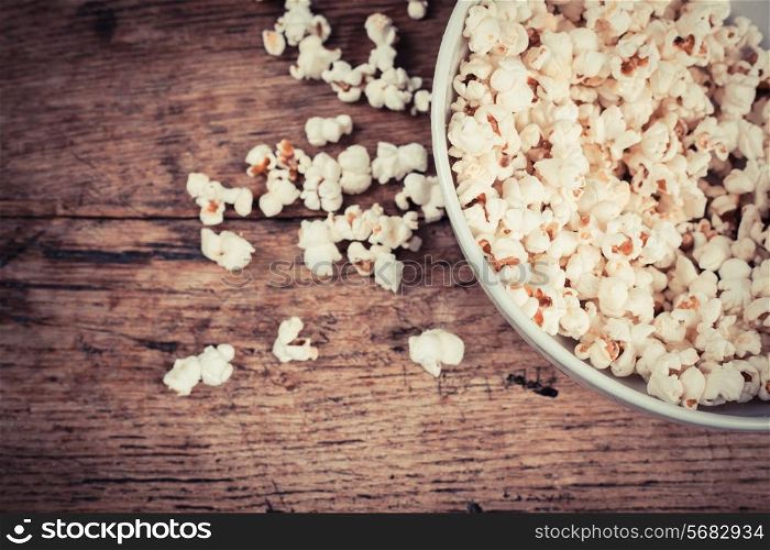 A bowl of popcorn on a wooden table
