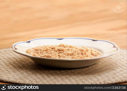 A bowl of porridge on a wooden table.