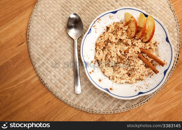 A bowl of porridge with apple and cinnamon spices