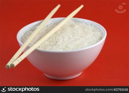 A bowl of rice, red background