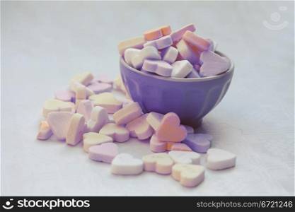 A bowl with heartshaped valentine candies