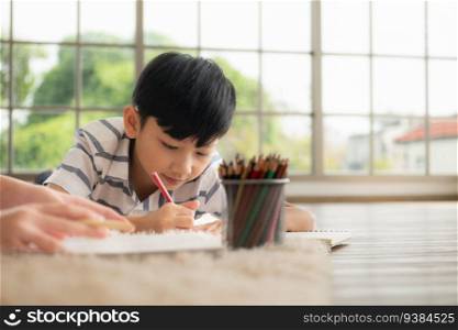 A boy and a daughter from an asian family. The children are having fun in the art of drawing.