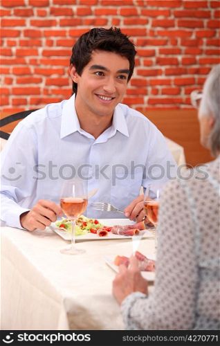 a boy and his grandmother at restaurant