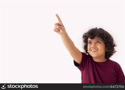 A BOY HAPPILY POINTING WHILE LOOKING ABOVE