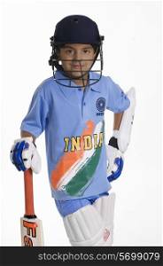 A boy in a cricketer&rsquo;s outfit