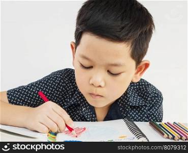 A boy is curiously doing homework