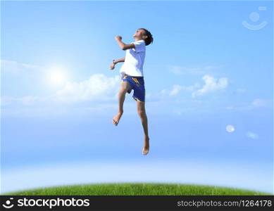 A boy jumps on a summer background of blue sky. Happy, joy, good mood