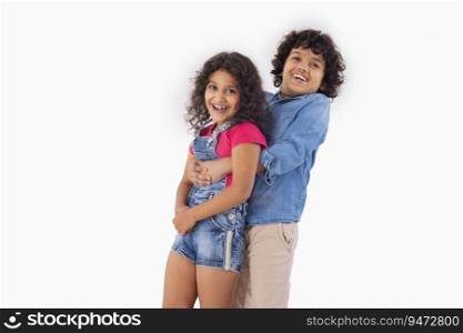 A boy lifting up his sister by holding from back 