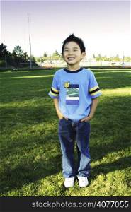 A boy posing at a park
