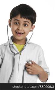 A boy wearing a doctor&rsquo;s coat
