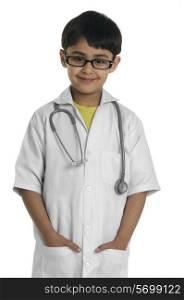 A boy wearing a doctor&rsquo;s coat