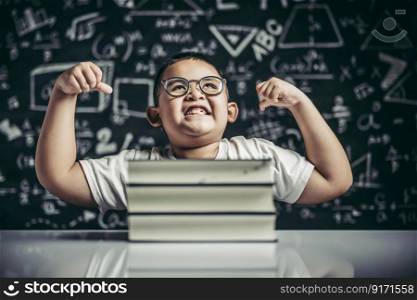 A boy with glasses sitting in the study and with both arms perpendicular