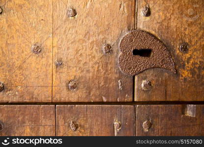 a brass brown knocker and wood door castiglione olona varese italy