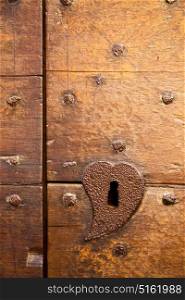a brass brown knocker and wood door castiglione olona varese italy