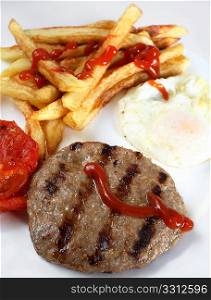 A breakfast of grilled beefburger, fried egg, chips (or french fries) and grilled tomato, close-up