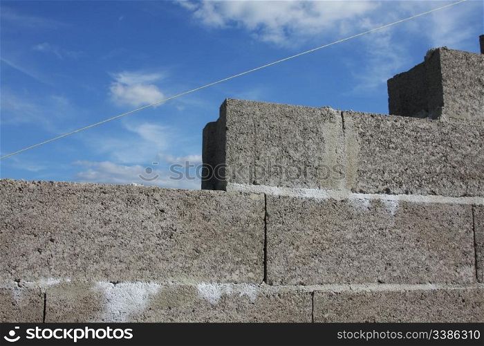 A brick wall against a deep blue sky