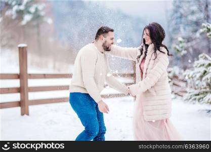 a bride in a fur coat with a fiance among the Carpathian mountains