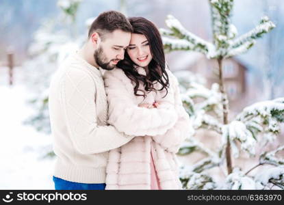 a bride in a fur coat with a fiance among the Carpathian mountains