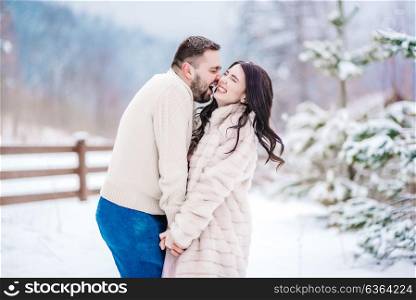 a bride in a fur coat with a fiance among the Carpathian mountains