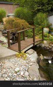 A bridge spans the water drainage on a property