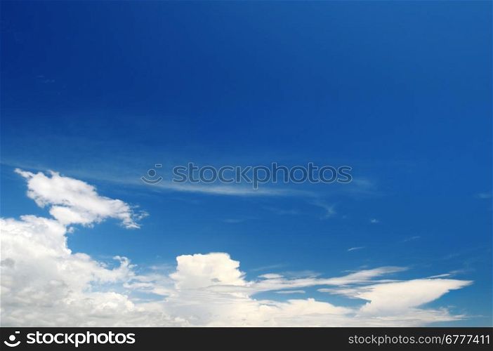 a bright blue sky and stratus clouds