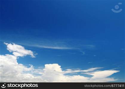 a bright blue sky and stratus clouds