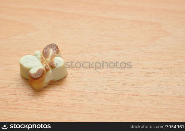 A brown and white butterfly shape chocolate