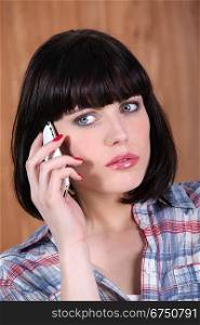 a brunette woman at phone