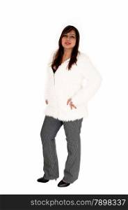 A brunette young woman standing isolated for white background in a whitejacket and grey pants.