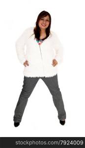 A brunette young woman standing isolated for white background wearinga short white jacket an high heels.