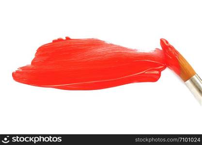 a brush in red paint and a smeared spot of orange acrylic paint on a white blank sheet of paper.