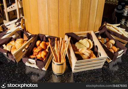 A buffet table with variety of bread in the wooden baskets. Buffet table with variety of bread in the wooden baskets